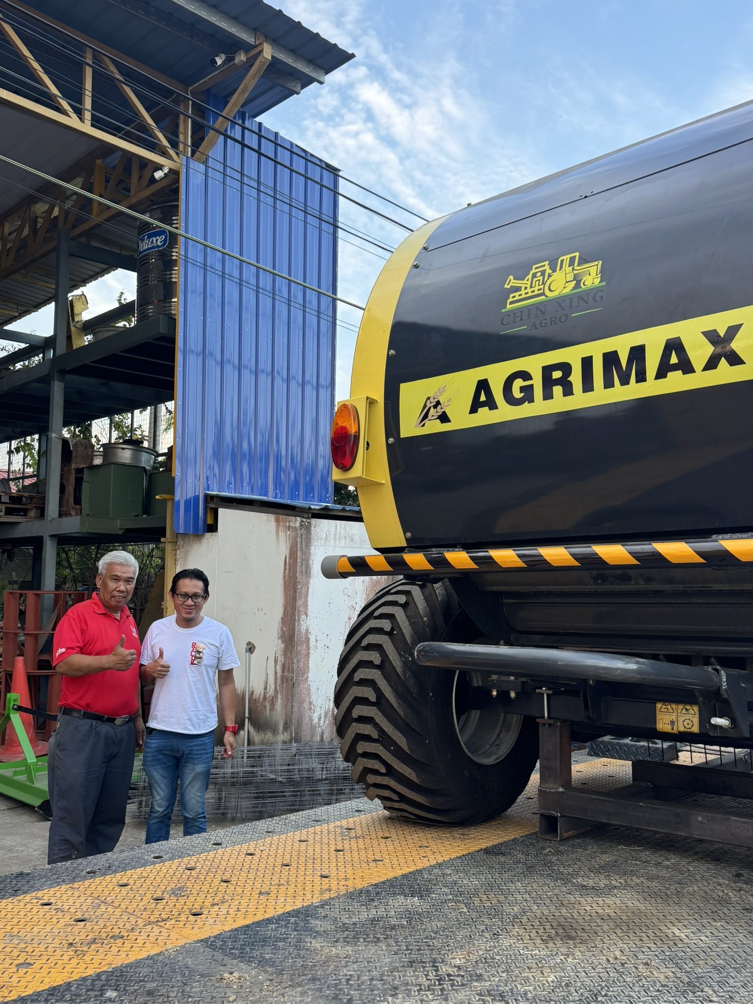 Chin Xing Agro team beside an Agrimax machinery unit